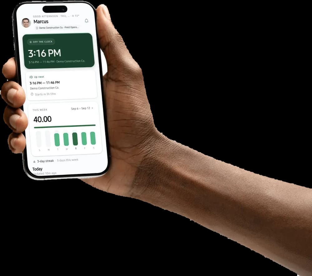 A hand holding a phone running the VEA app: the clock-in card, the next shift, and this week's hours.